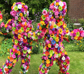 Garden themed entertainment - hire fun FLOWER PEOPLE TO HIRE - BLOSSOM IN HUGS FUN WALKABOUT FLORAL ACT