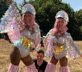 Festival themed Glitter Stilt walkers hire uk